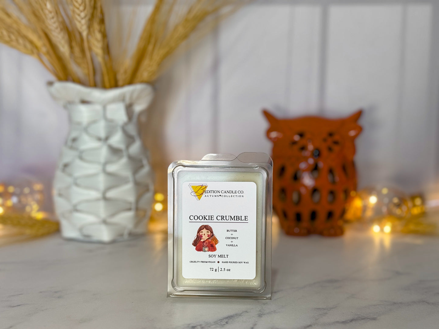 Cookie Crumble wax melt in clear packaging, set against a cozy decor background with an owl and dried flowers.